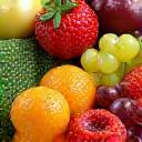 Close up of fresh fruits and vegetables like berries, oranges, and greens